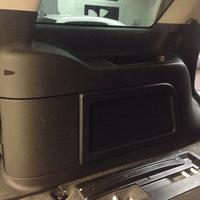 subwoofer is mounted behind quarter panel cover