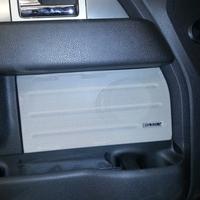 Front speakers mounted behind door panel