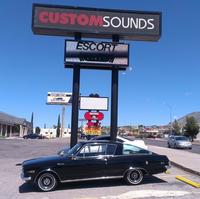Black 1965 Plymouth Barracuda Valiant displayed outside of Custom Sounds